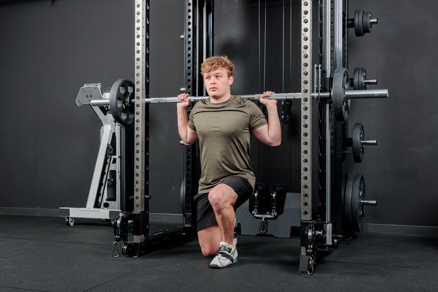 Athlete using the REP Fitness Altitude™ Power Rack Smith Machine Attachment for lunges