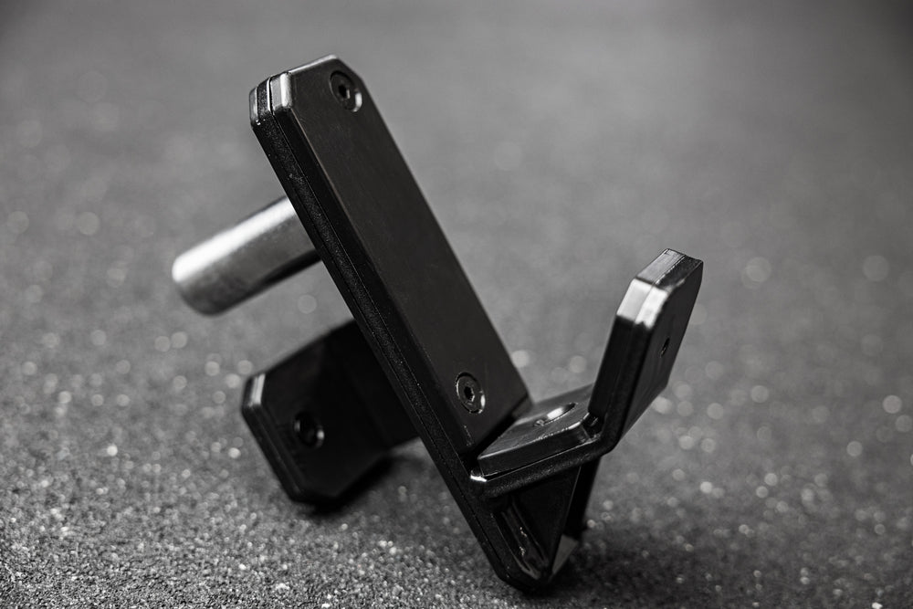 Side shot of the REP Fitness Altitude™ J-Cup sitting on a gym floor