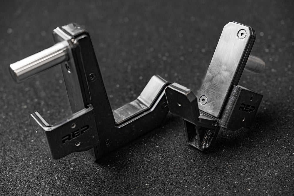 REP Fitness Altitude™ J-Cups sitting upright on a gym floor