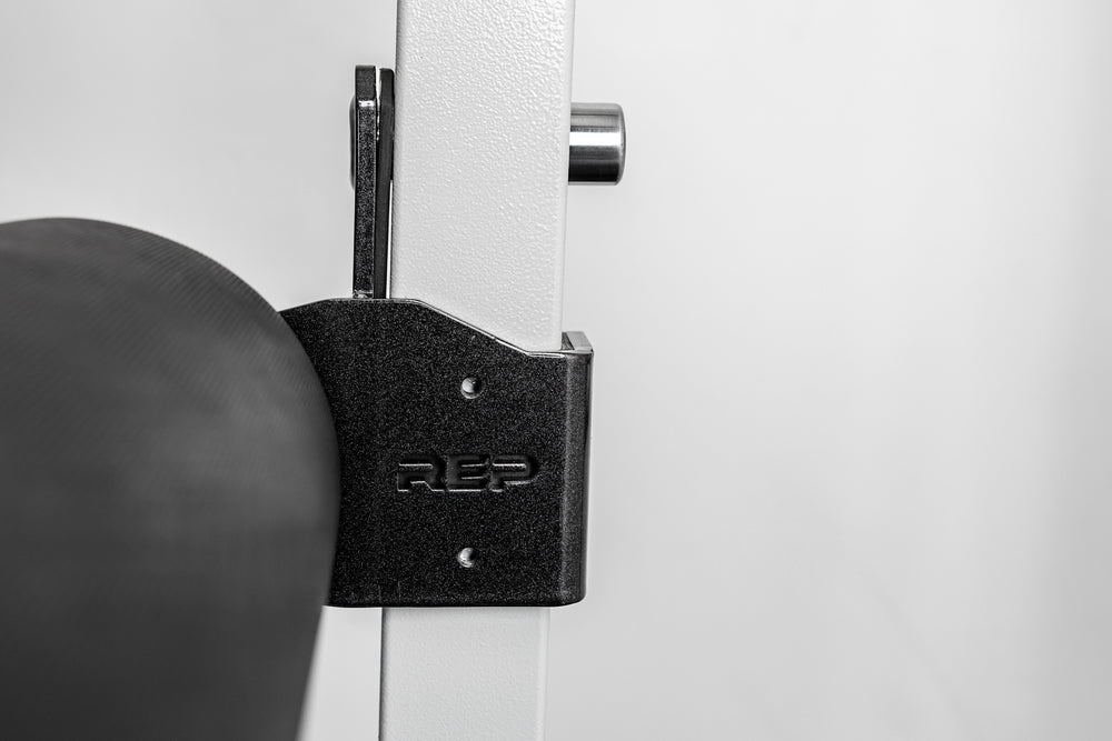 Side-shot of the REP Fitness Altitude™ Leg Roller hardware installed on the rack upright