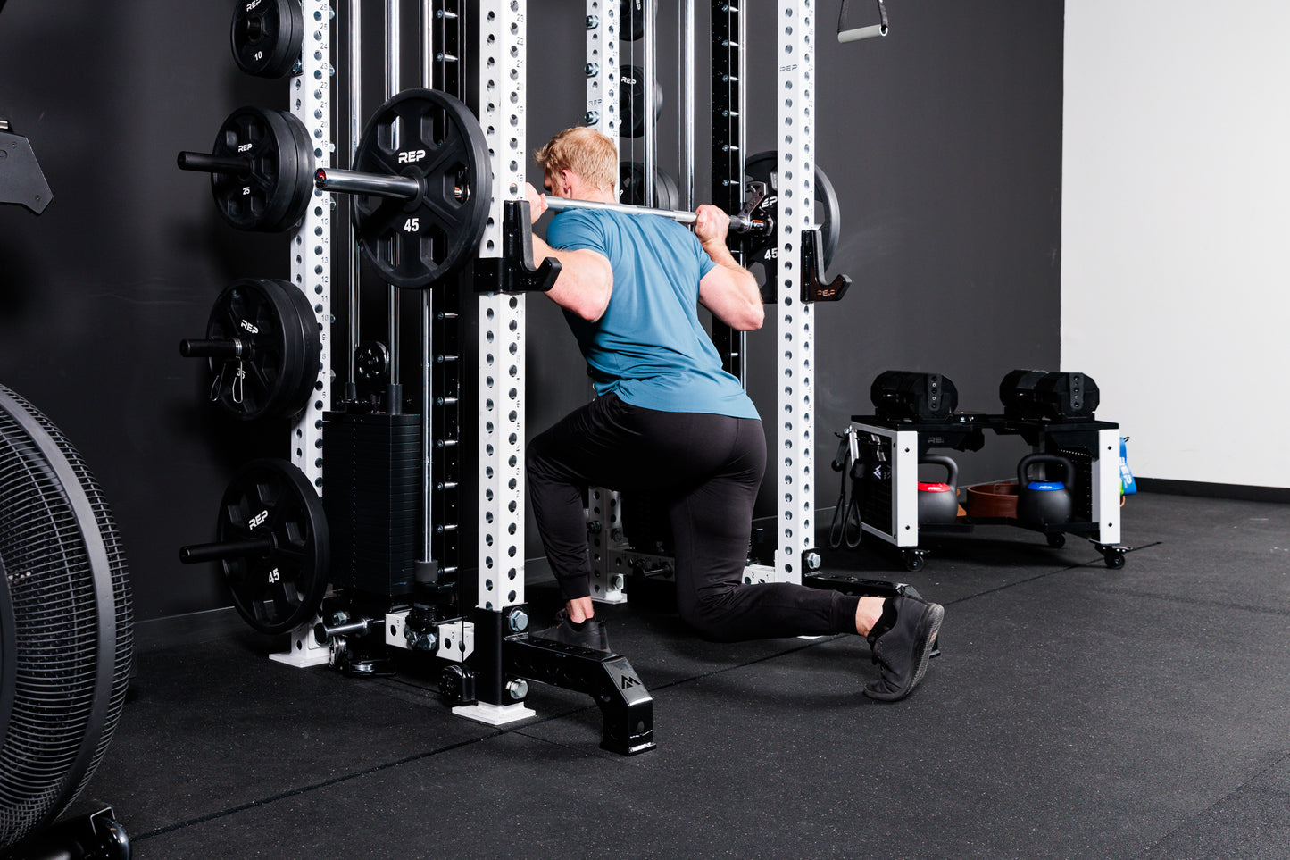 Person performing lunges with the Smith Machine Rack Attachment on the Summit™ All-In-One Athena™ .