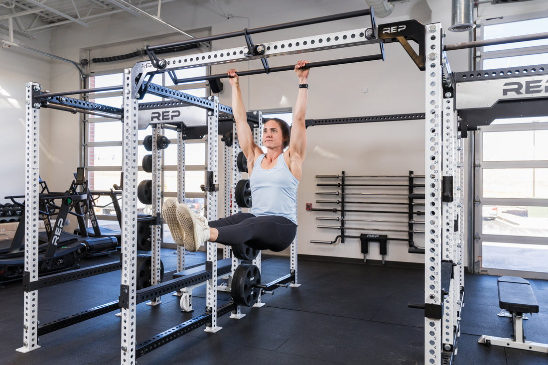 Athlete hanging from the REP Fitness Double Pull-Up Bar on an 82 inch crossmember