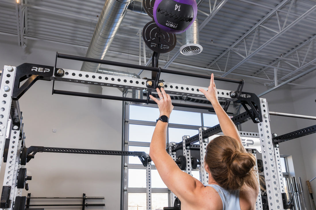 Athlete doing wall balls on the REP Fitness Crossmember Mount Wall Ball Target