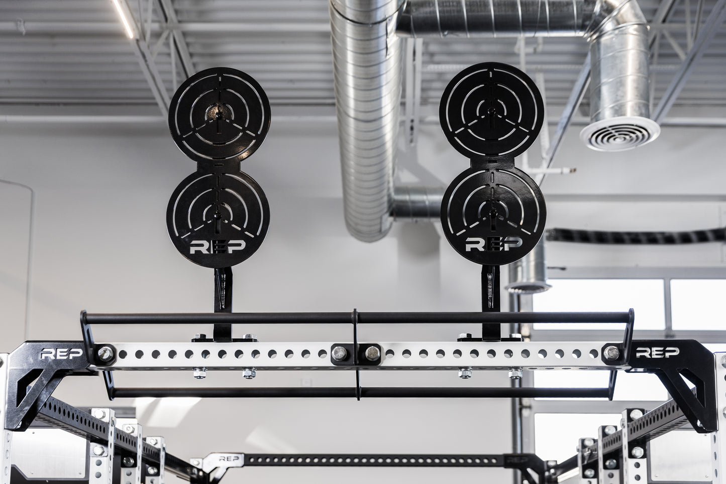 Two of the REP Fitness Crossmember Mount Wall Ball Targets on an 82 inch crossmember