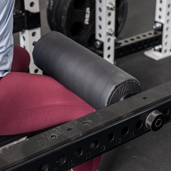 Athlete using the Leg Roller 2.0 as a leg restraint on the Flip-Down Safeties 2.0