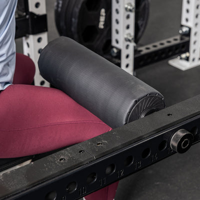 Athlete using the Leg Roller 2.0 as a leg restraint on the Flip-Down Safeties 2.0