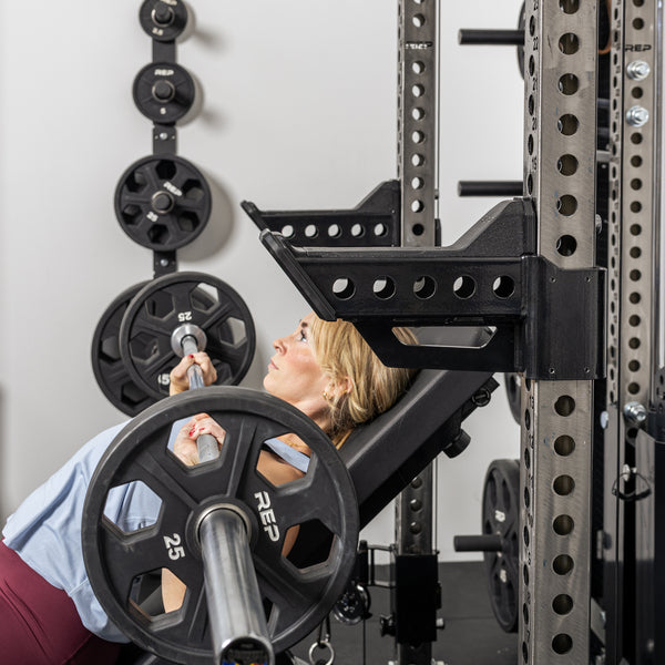 Athlete doing incline bench with the short Spotter Arms 2.0 set up to use as a place to rack the bar