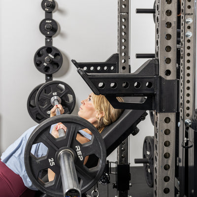 Athlete doing incline bench with the short Spotter Arms 2.0 set up to use as a place to rack the bar
