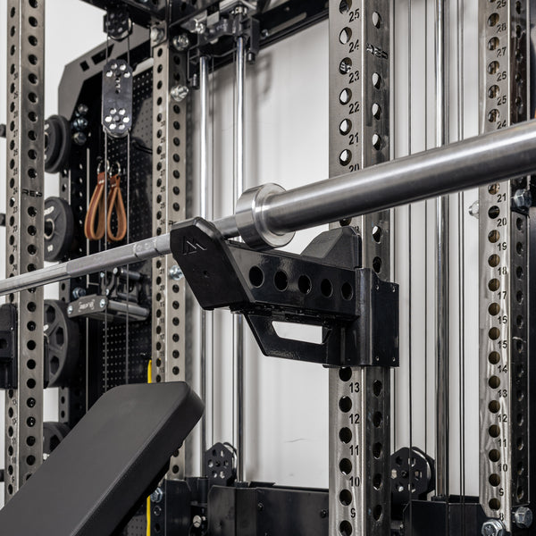 A barbell resting on the short Spotter Arms 2.0 set up in a racked position