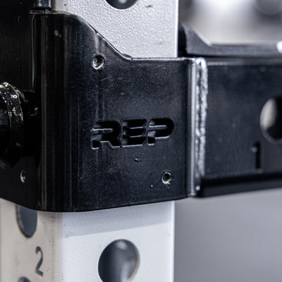 Close-up shot of the branding on the REP Fitness Flip-Down Safeties 2.0