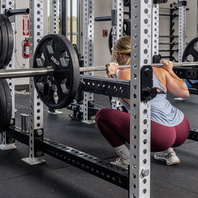 Athlete squatting with the Flip-Down Safeties 2.0 below the bar
