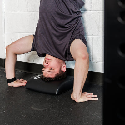 Athlete using the REP Fitness Ab Support Mat 2.0 for head support.