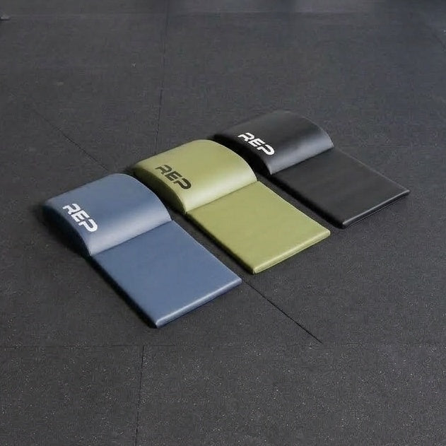 The REP Fitness Ab Support Mat 2.0 in three colors with tailbone