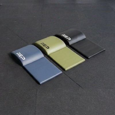 The REP Fitness Ab Support Mat 2.0 in three colors with tailbone