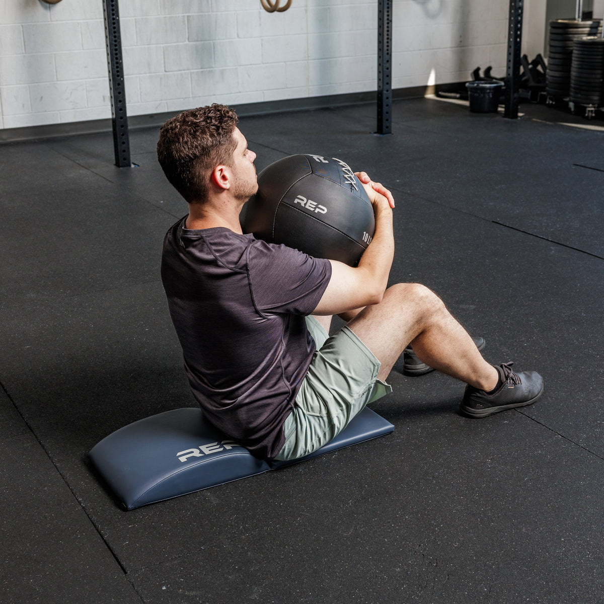 Athlete doing a sit up using the REP Fitness Ab Support Mat 2.0
