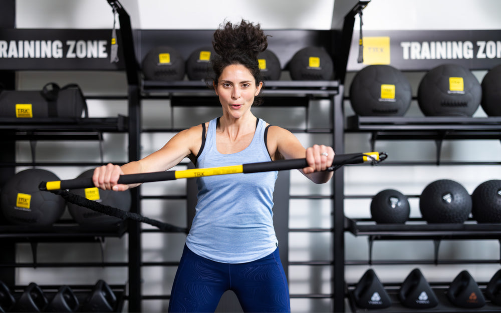 Front shot: Athlete working out with the TRX® Rip Trainer™ extended in front of them horizontally