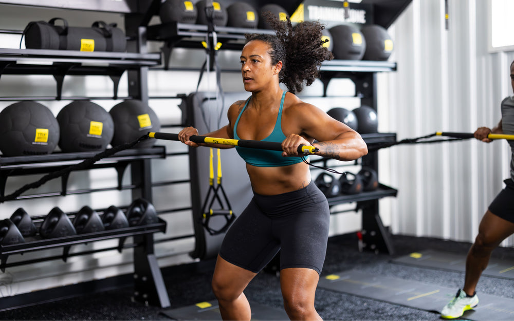 Side shot: Athlete holding the TRX® Rip Trainer™ in front of them at chest height