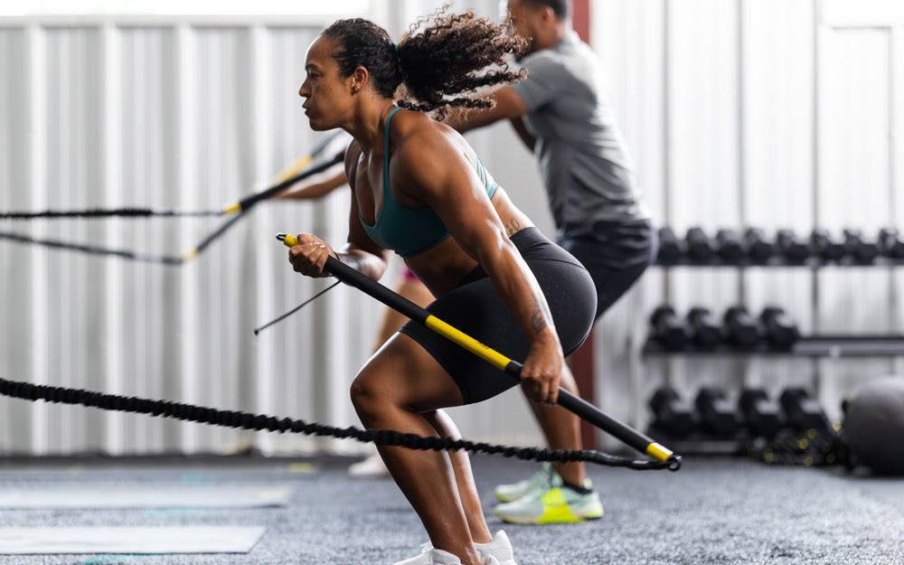Side shot: Athlete pulling the TRX® Rip Trainer™ at past the side of their body against the resistance of the band