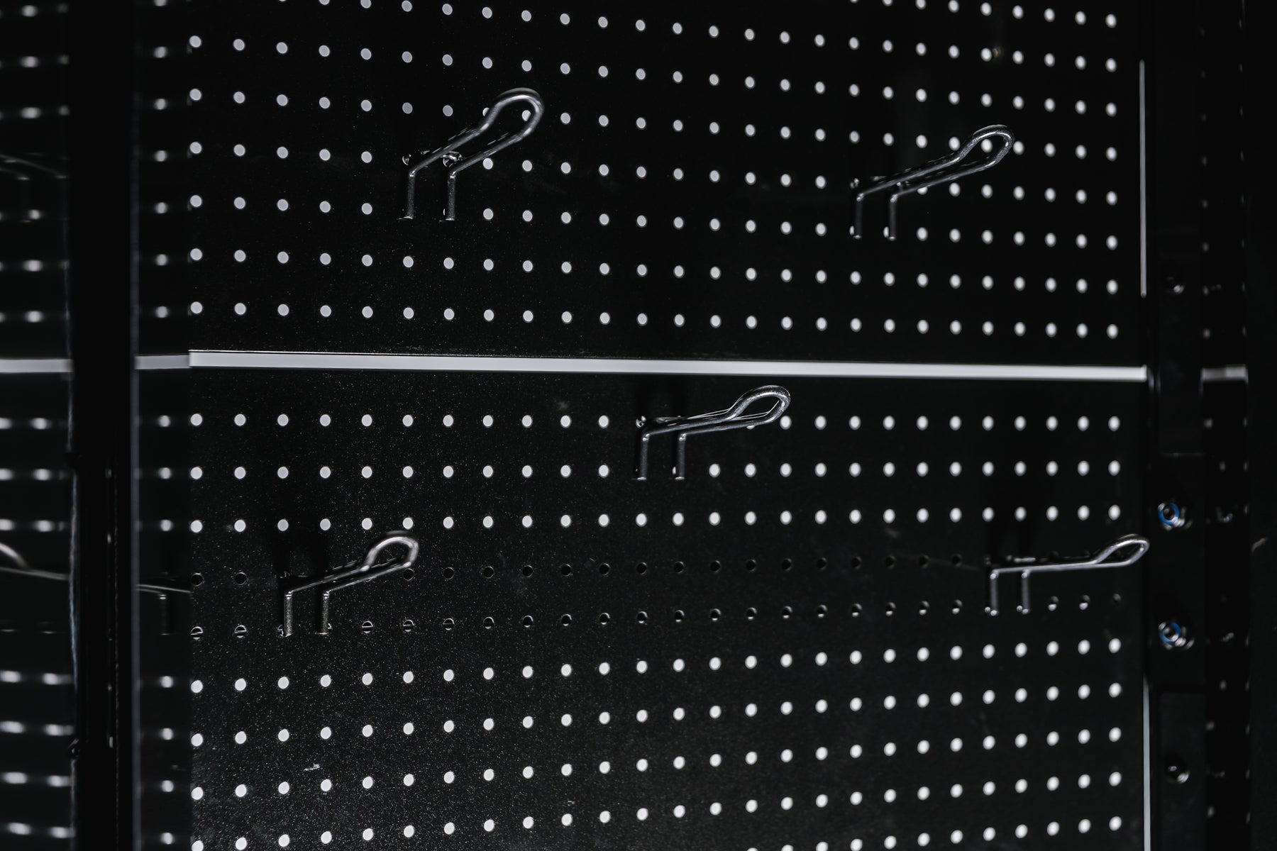 Pegboard storage hooks on a black Arcadia Max