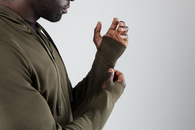 A man wearing the Attis Jacket in 
Heather Olive
