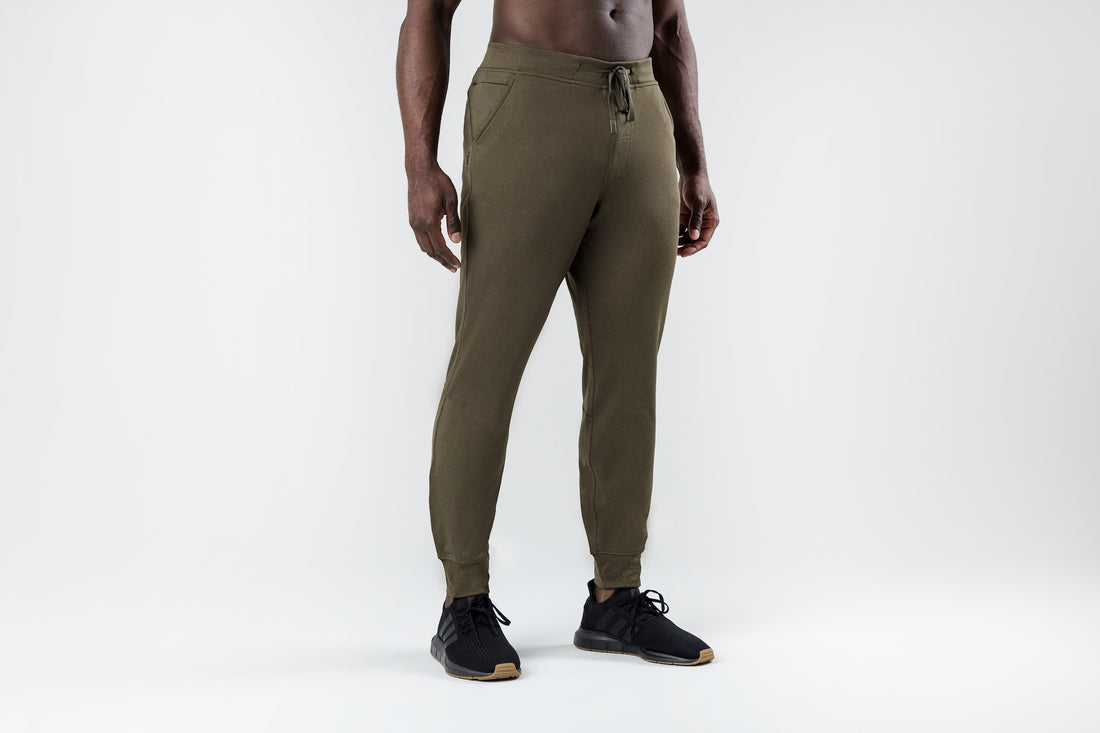 The REP Fitness Men's Attis Joggers in Heather Olive front, hands near pockets