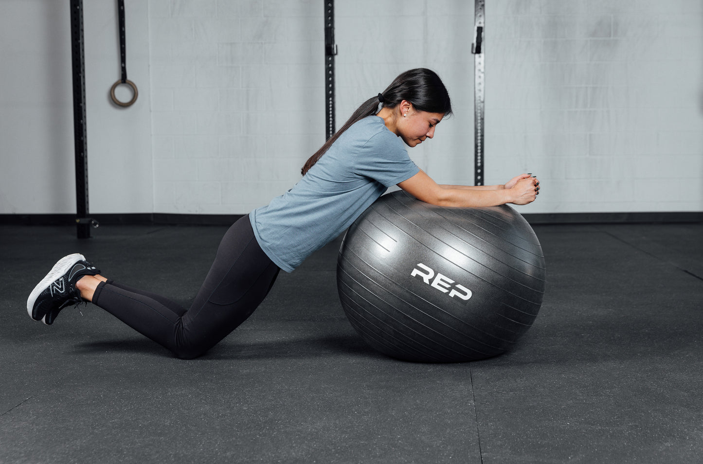 An athlete doing ball roll outs with the REP Physioball