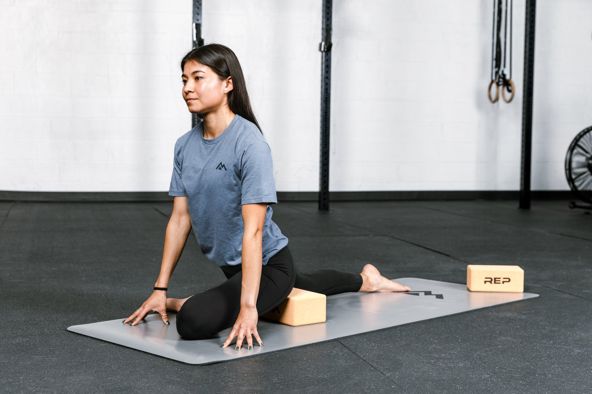 Athlete performing a stretch with REP's cork yoga blocks.