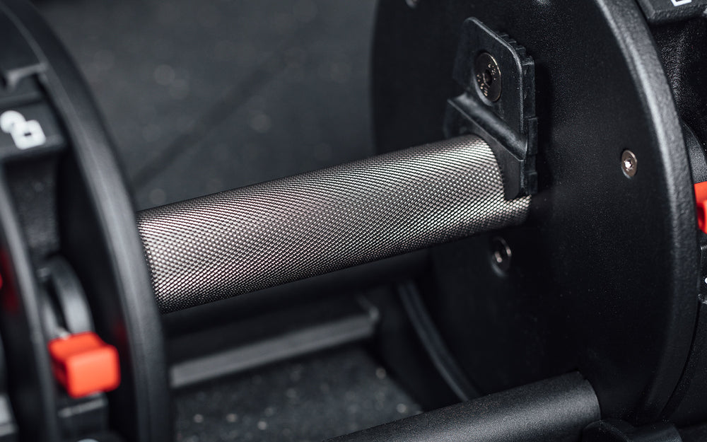 Close-up view of the fully knurled handle of the REP Fitness QuickDraw Adjustable Dumbbell.