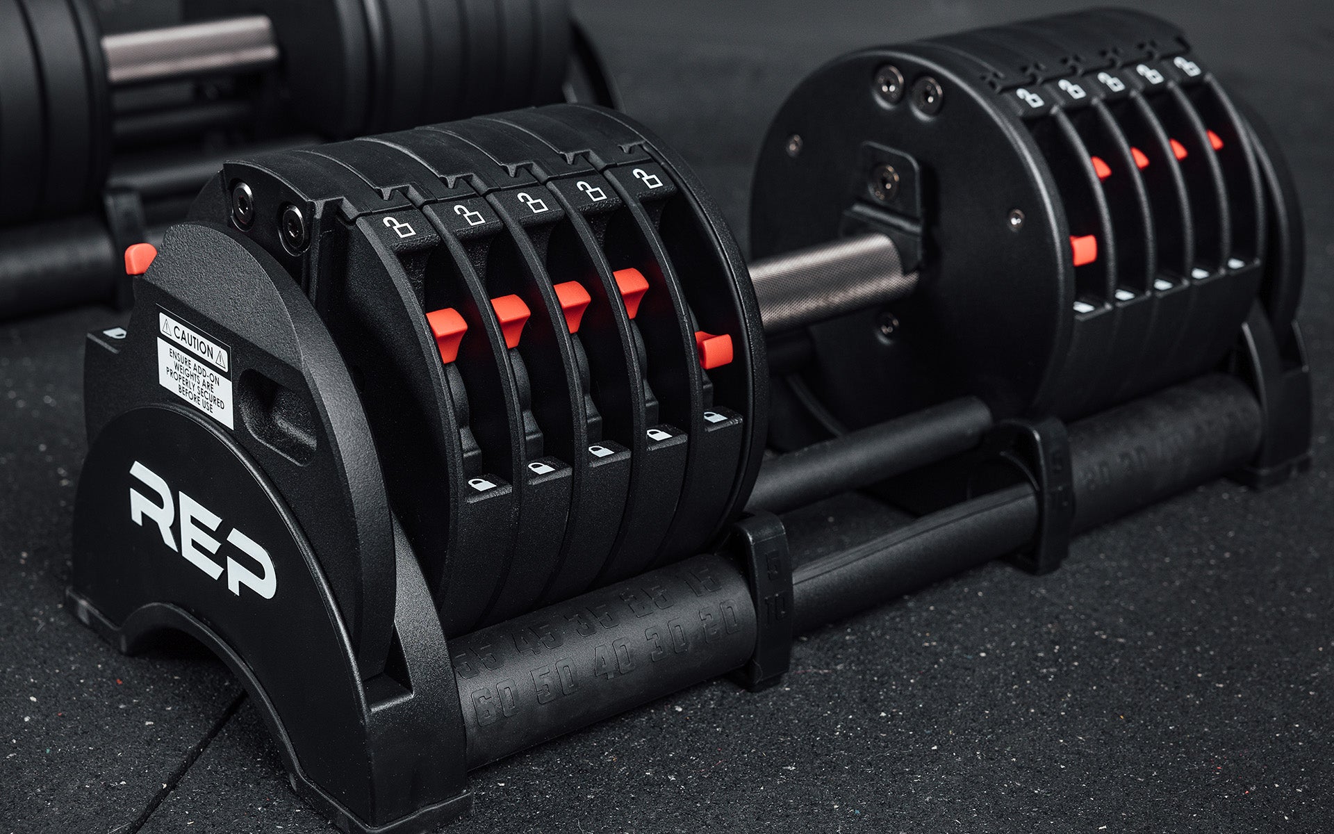 Close-up view of a single 60lb REP Fitness QuickDraw Adjustable Dumbbell.