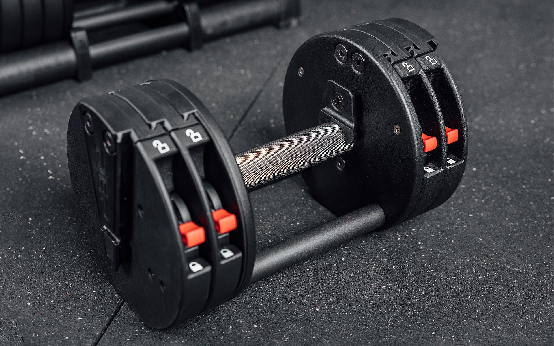 Close-up view of a single REP Fitness QuickDraw Adjustable Dumbbell out of it's cradle.