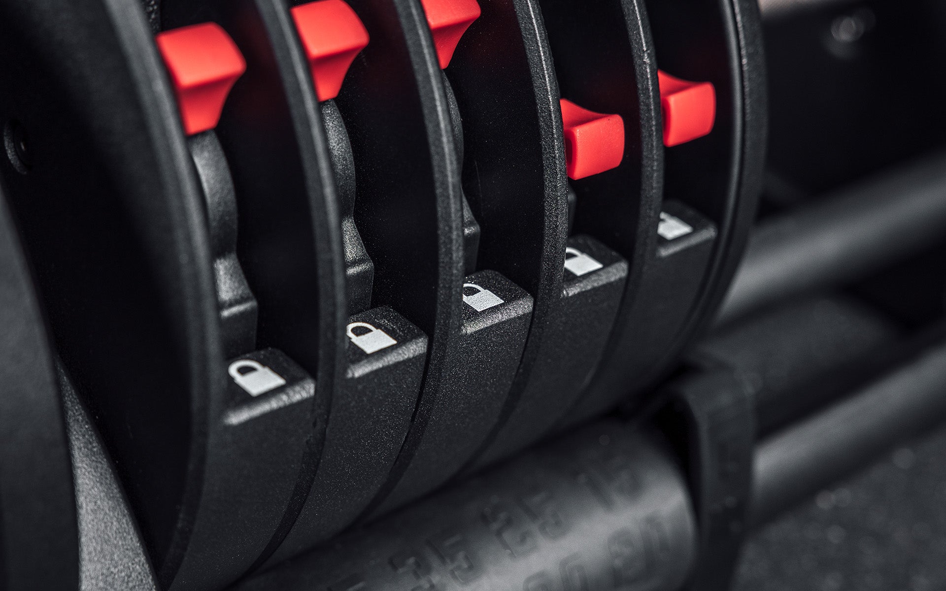Close-up view of the red switches which serve as the locking mechanism when selecting the amount of weight for your REP Fitness QuickDraw Adjustable Dumbbell.