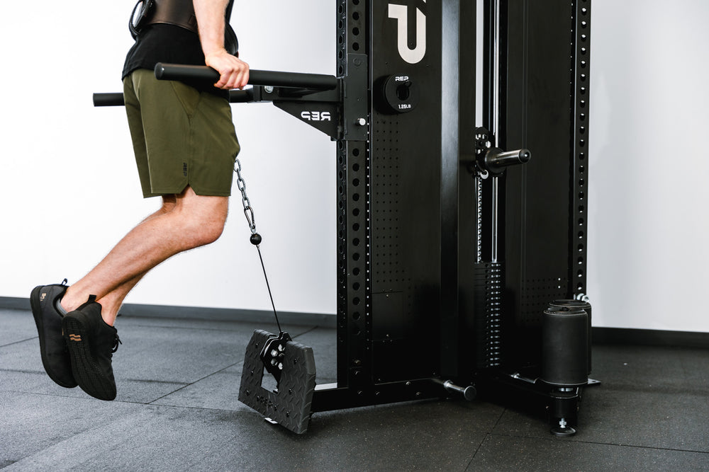 Adonis™ Cable Tower with Dip Attachment. Being used for weighted dips