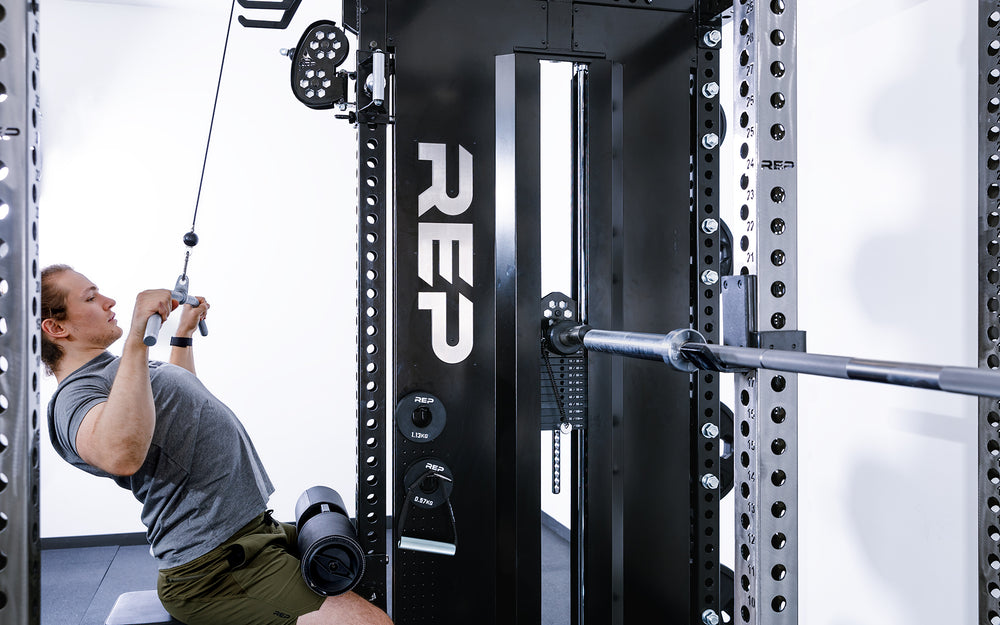 Man doing lat pulldowns using the Pegasus Attachment on the Adonis.