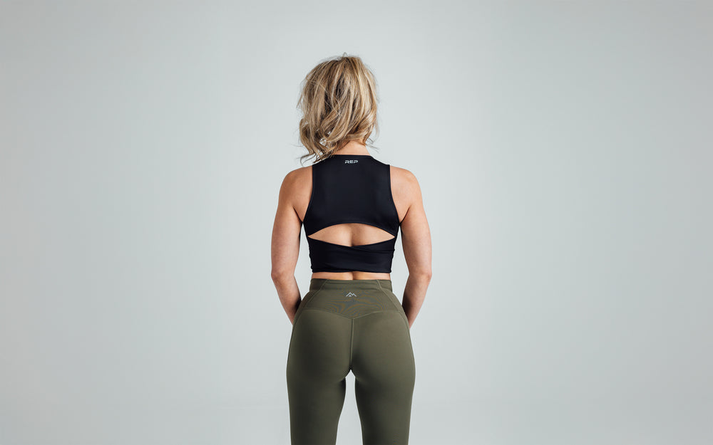 Back shot of an athlete wearing the REP Rhea Tank in Black.