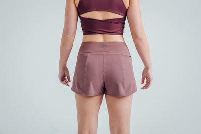 Back shot: Athlete wearing the Mauve Women’s Artemis Shorts on a white background