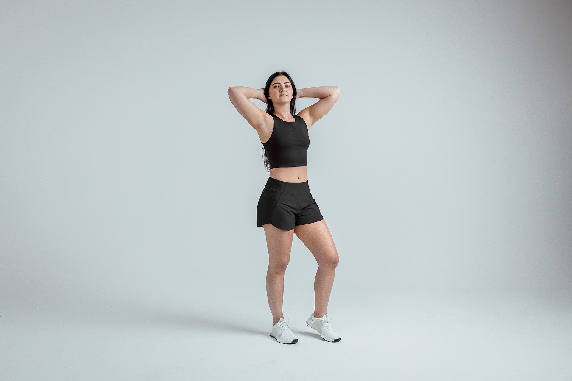 Full body shot: Athlete striking a pose in the Black Women’s Artemis Shorts