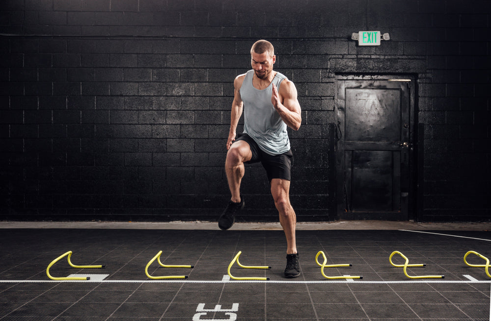 Athlete doing agility drills in the black Men's Motus Shorts