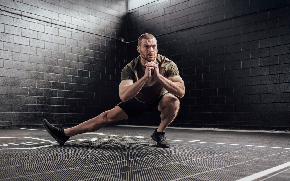 Athlete stretching wearing Heather Olive Sigmatech Shirt