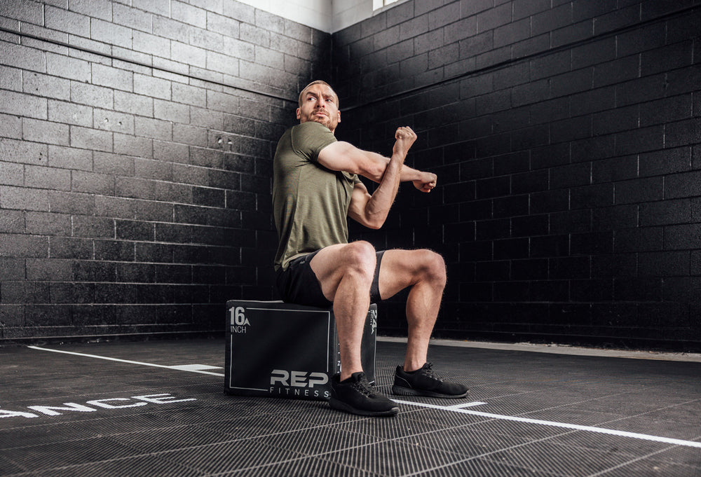Athlete stretching in a Heather Olive Sigmatech Shirt