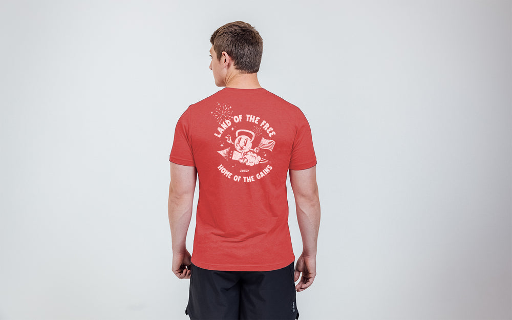 Back view of the REP Men's Liberty Bell Tri-Blend Crew T-Shirt on a model in Red with a White Graphic