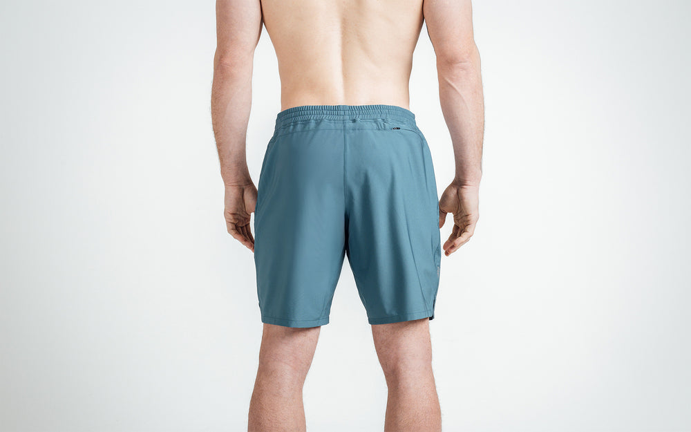 Athlete wearing slate Men's Motus Shorts, back view