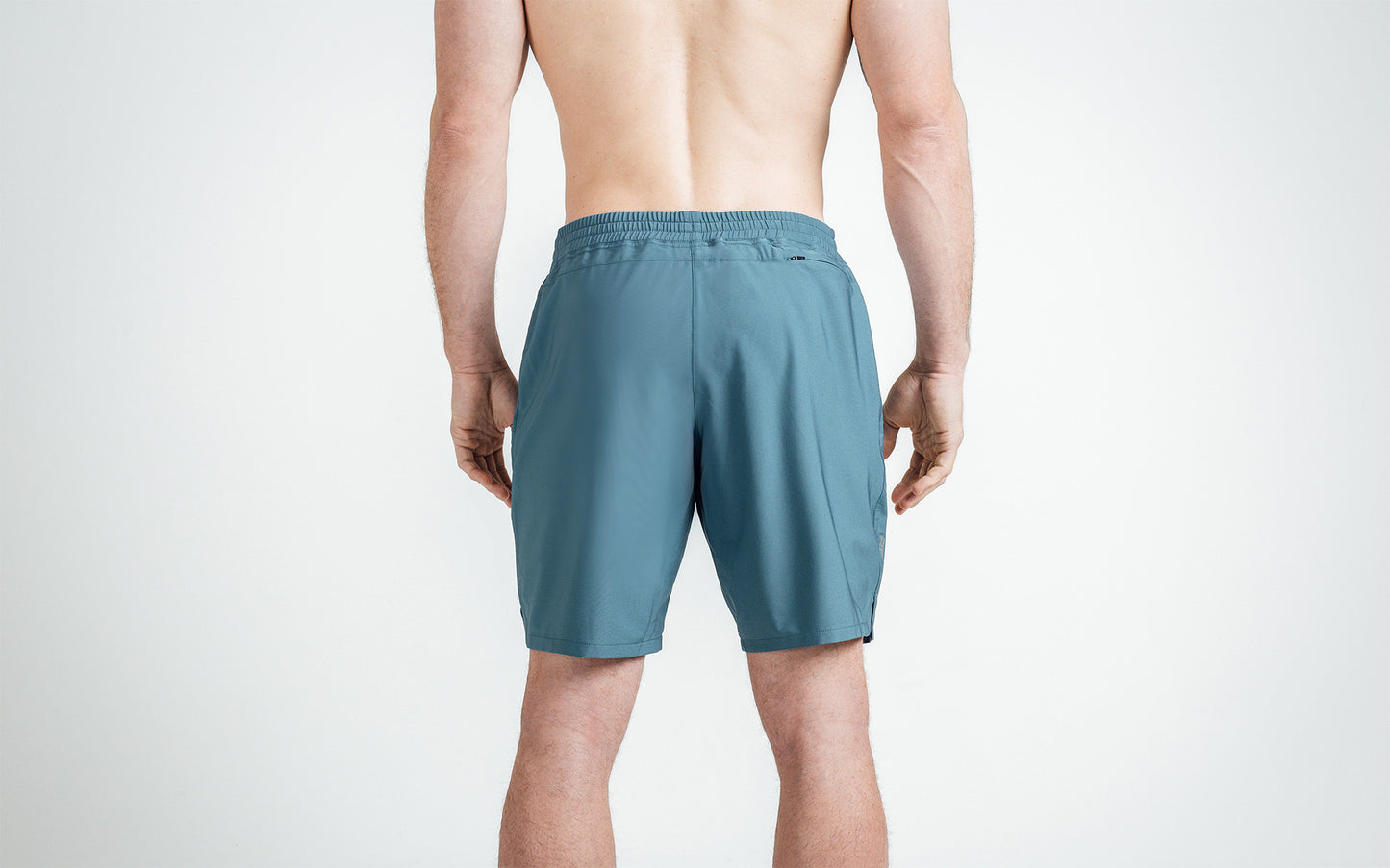 Athlete wearing Slate Men's Motus Shorts, back view