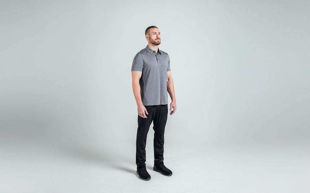 A 3/4 shot of an athlete wearing the REP Audax Polo in 
Heather Cool Gray. The forward shoulder seams and angled 
side seams create an athletic look, visually slim waist, and 
accentuate shoulders