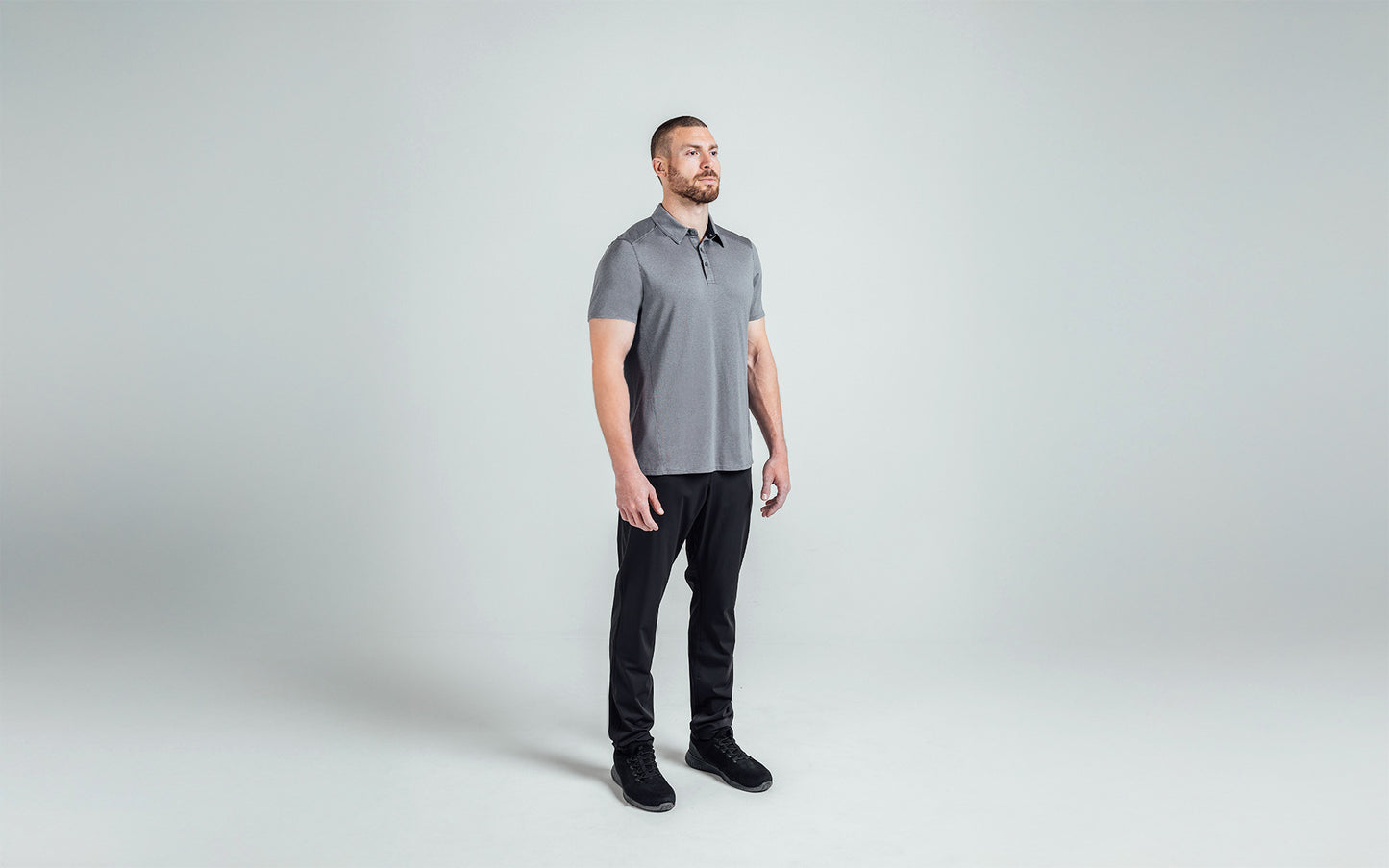A 3/4 shot of an athlete wearing the REP Audax Polo in 
Heather Cool Gray