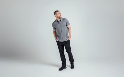 A posed front shot of an athlete wearing the REP Audax 
Polo in Heather Cool Gray