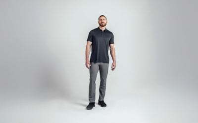 A front shot of an athlete wearing the REP Audax Polo in 
Heather Black