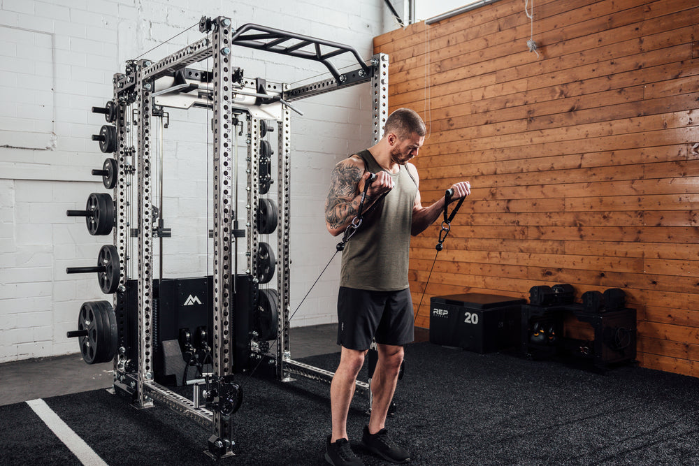 Athlete exercising outside a rack, wearing black Men's Motus Shorts