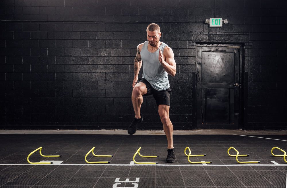 Athlete doing agility drills in the black Men's Motus Shorts