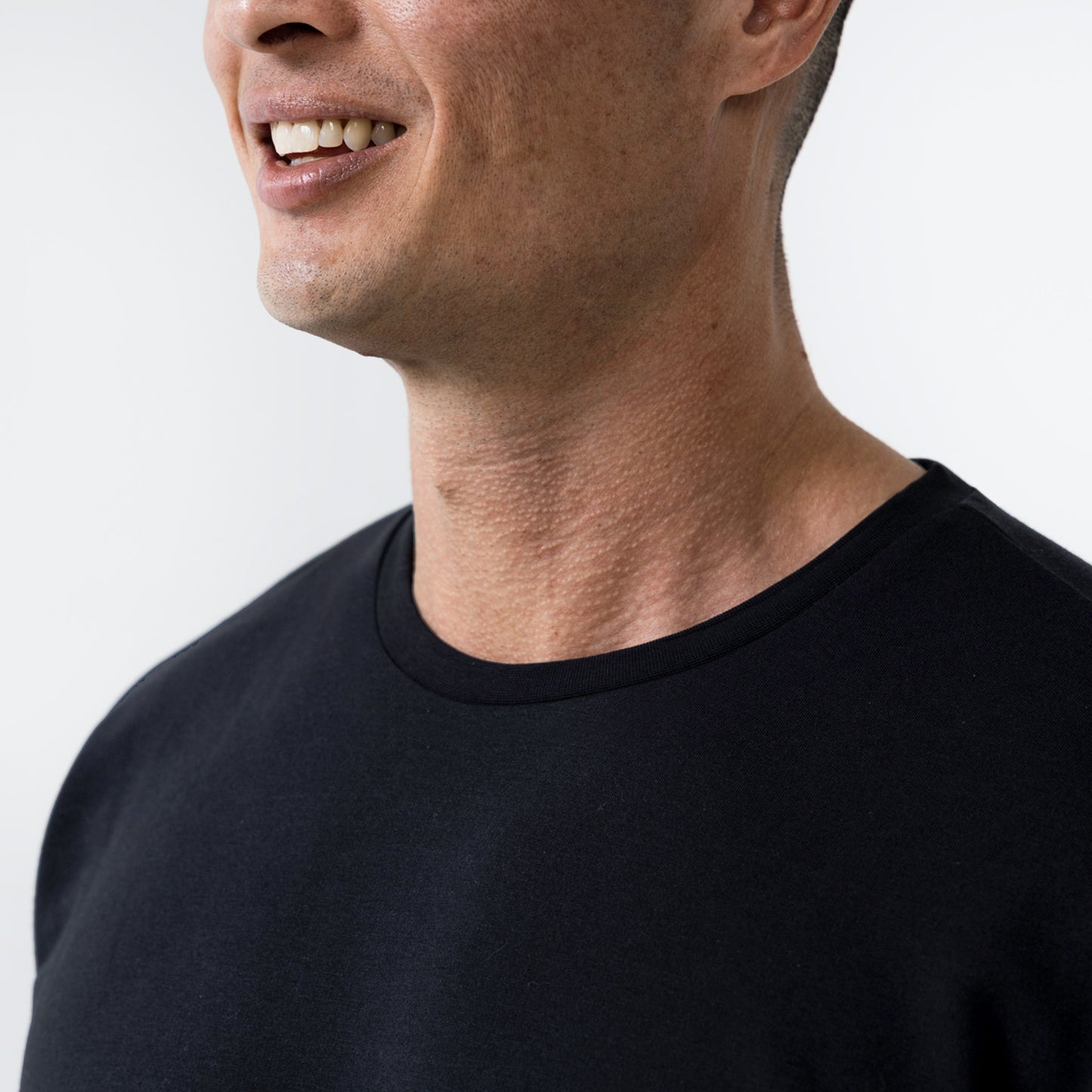 Men's Magnis Heavyweight T-Shirt in Black on person . Close-up of neck line