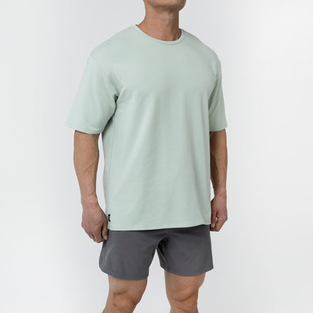 Men's Magnis Heavyweight T-Shirt in Aqua Gray on person with grey shorts on a white background